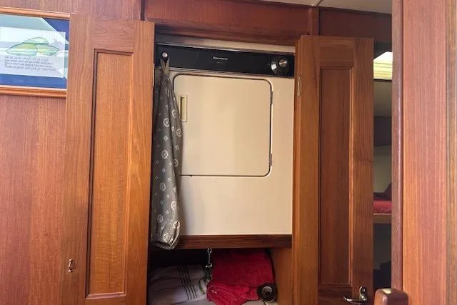 Slide: The Image of 1988 Viking 45 Convertible interior with wooden cabinetry and built-in laundry unit. - 25