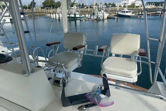 Slide: The Image of 1988 Viking 45 Convertible yacht helm with two chairs, overlooking marina. - 26