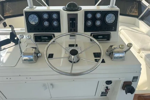 Slide: The Image of 1988 Viking 45 Convertible helm with gauges, steering wheel, and controls. - 32