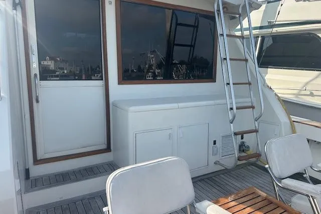 Slide: The Image of 1988 Viking 45 Convertible yacht deck with seating and ladder. - 6