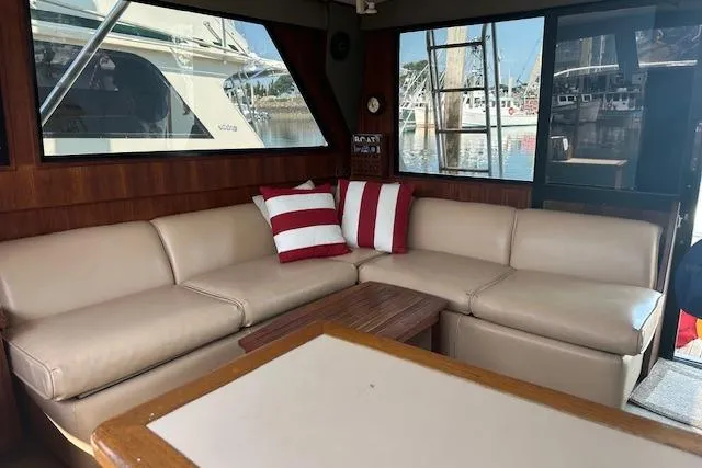 Slide: The Image of Interior of 1988 Viking 45 Convertible yacht with beige leather seating and striped cushions. - 8