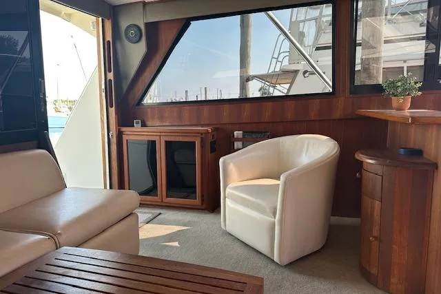 Slide: The Image of Interior of 1988 Viking 45 Convertible yacht with modern seating and wooden accents. - 9