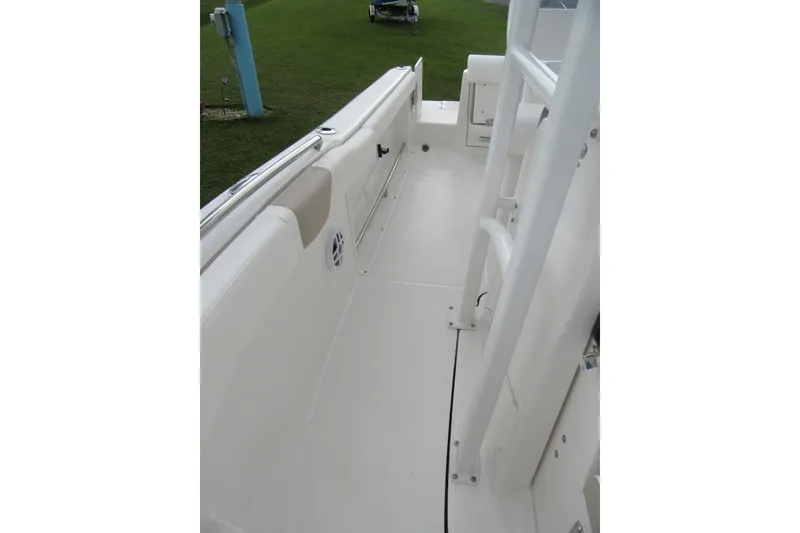 Slide: The Image of 2026 Robalo R222 Center Console boat interior, featuring sleek white deck and seating. - 10