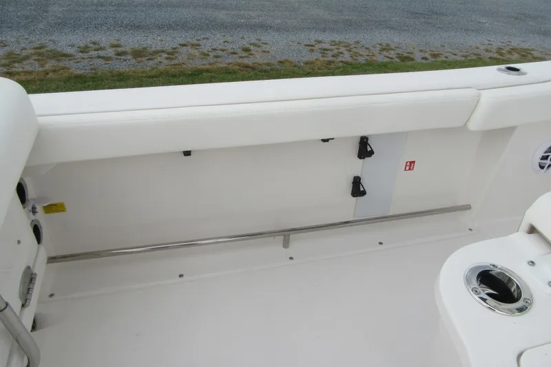 Slide: The Image of 2026 Robalo R222 Center Console boat interior, featuring white seating and stainless steel accents. - 11