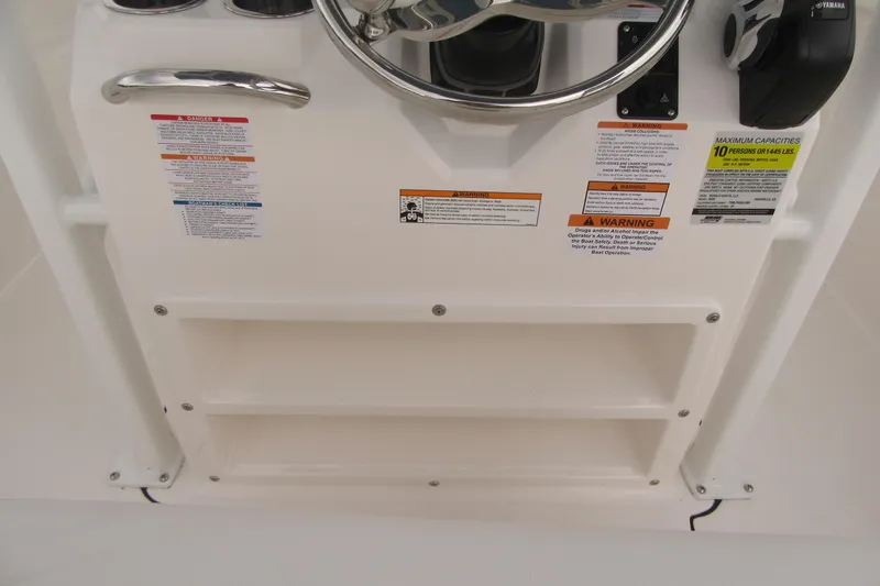 Slide: The Image of 2026 Robalo R222 Center Console dashboard with steering wheel and safety warnings. - 15