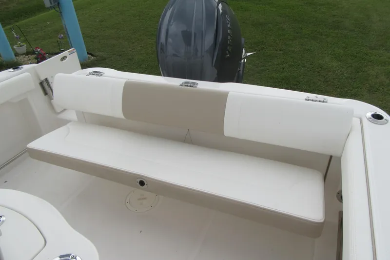 Slide: The Image of 2026 Robalo R222 Center Console boat with cushioned seating and outboard motor. - 20