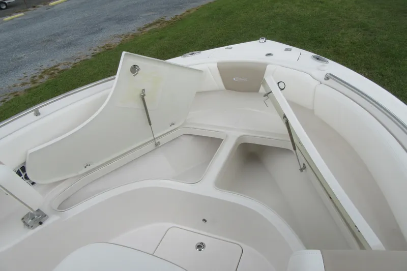Slide: The Image of 2026 Robalo R222 Center Console boat with open storage compartments on deck. - 6