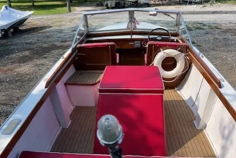 Slide: The Image of 1963 Chris-Craft Sea Skiff boat interior with red seating and wooden deck. - 8