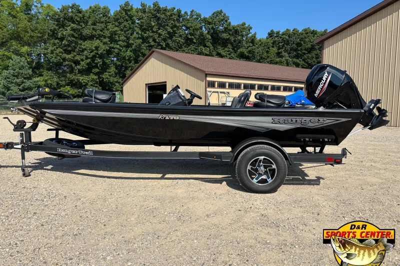 Slide: The Image of 2024 Ranger RT178 boat on trailer, parked outdoors near buildings and trees. - 2