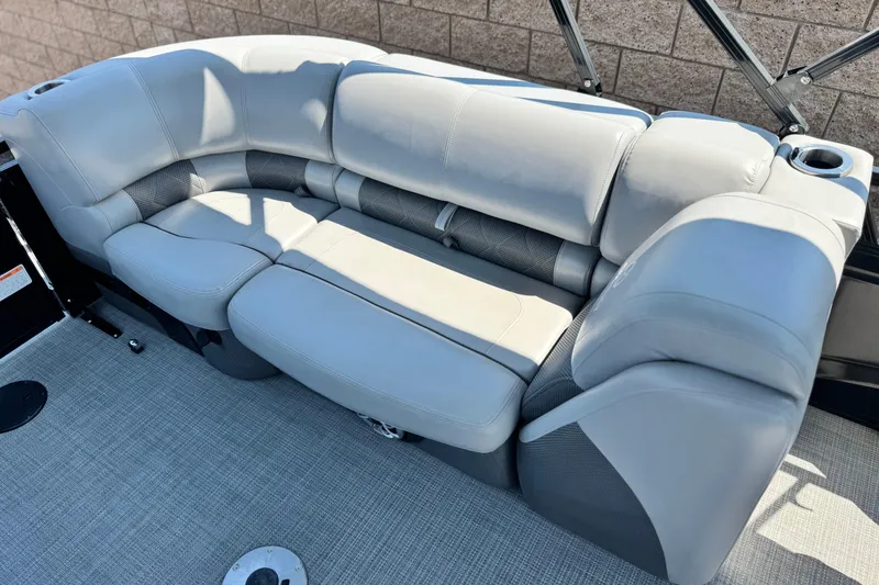 Slide: The Image of Luxurious seating on 2023 Regency 250 LE3 pontoon boat, featuring plush gray upholstery. - 18