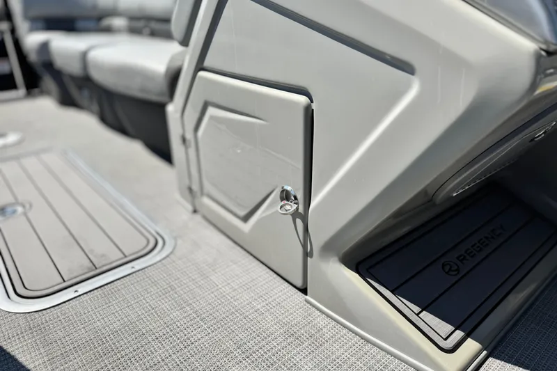 Slide: The Image of 2023 Regency 250 LE3 boat interior with seating and storage compartment. - 26