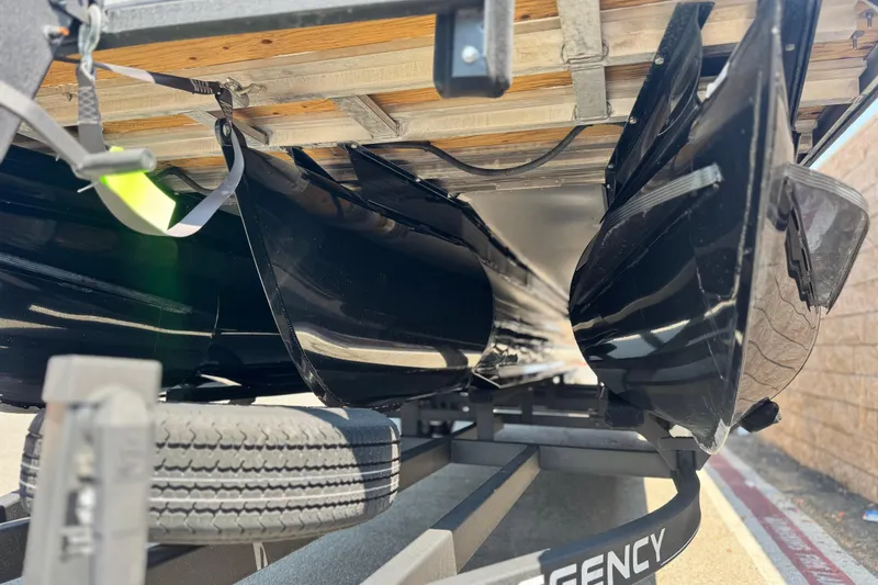 Slide: The Image of Underneath view of a 2023 Regency 250 LE3 pontoon boat on a trailer. - 4