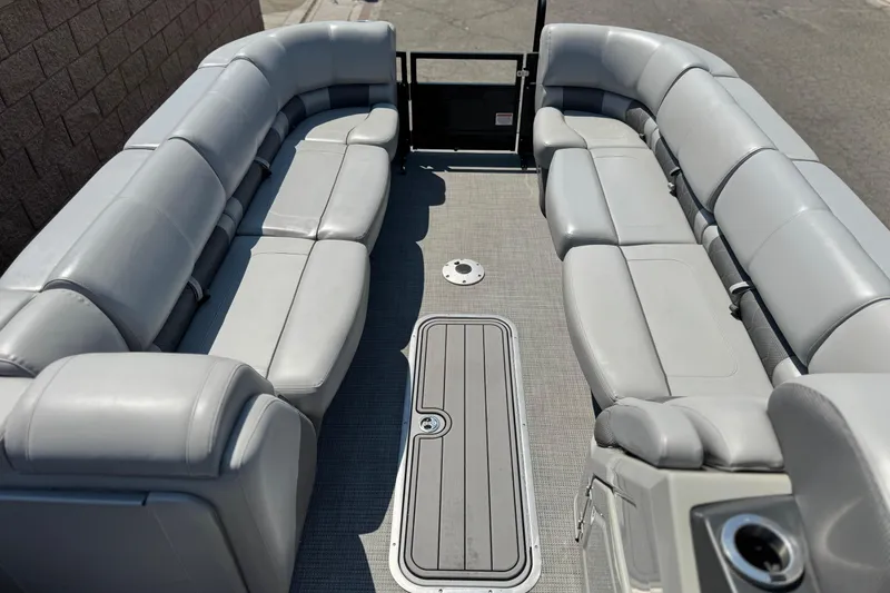 Slide: The Image of 2023 Regency 250 LE3 pontoon boat interior with spacious gray seating. - 9