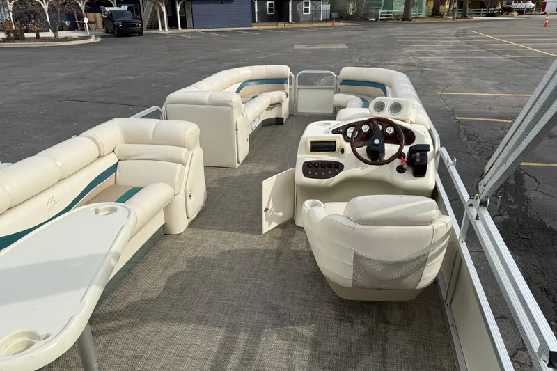 Slide: The Image of Interior of a 2001 Bennington 2550 RL pontoon boat with plush seating and steering console. - 10