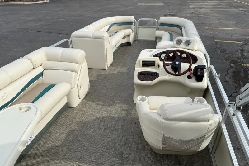 Slide: The Image of Luxurious 2001 Bennington 2550 RL pontoon boat with plush seating and modern dashboard. - 11
