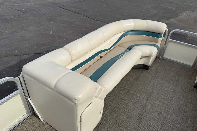 Slide: The Image of 2001 Bennington 2550 RL pontoon boat with beige and teal seating on a textured deck. - 18