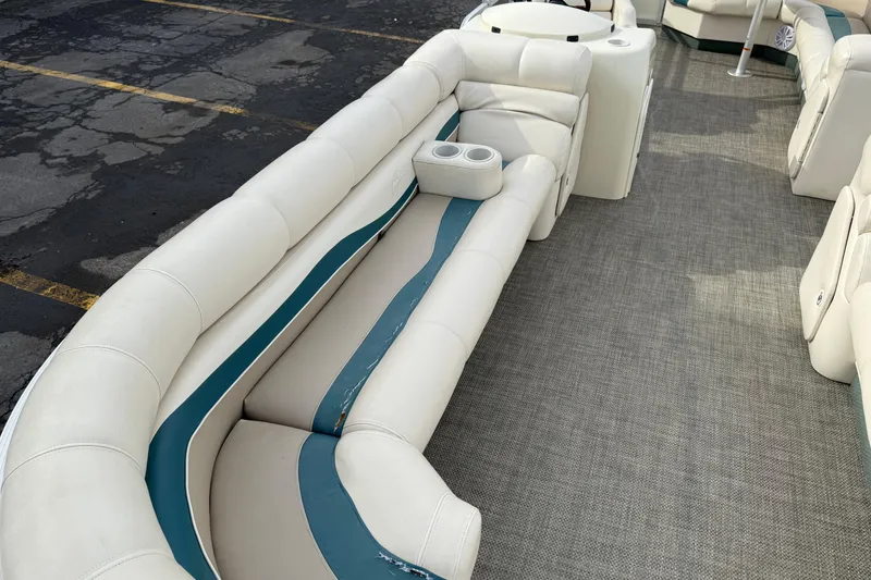 Slide: The Image of Interior of a 2001 Bennington 2550 RL pontoon boat with white seating and cup holders. - 19