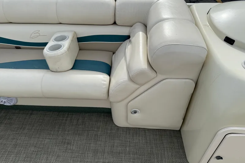 Slide: The Image of Bennington 2550 RL 2001 boat interior with white leather seating and cup holders. - 23