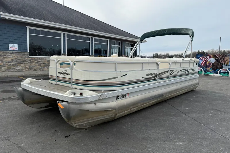 Slide: The Image of 2001 Bennington 2550 RL pontoon boat parked outside a building on a cloudy day. - 3