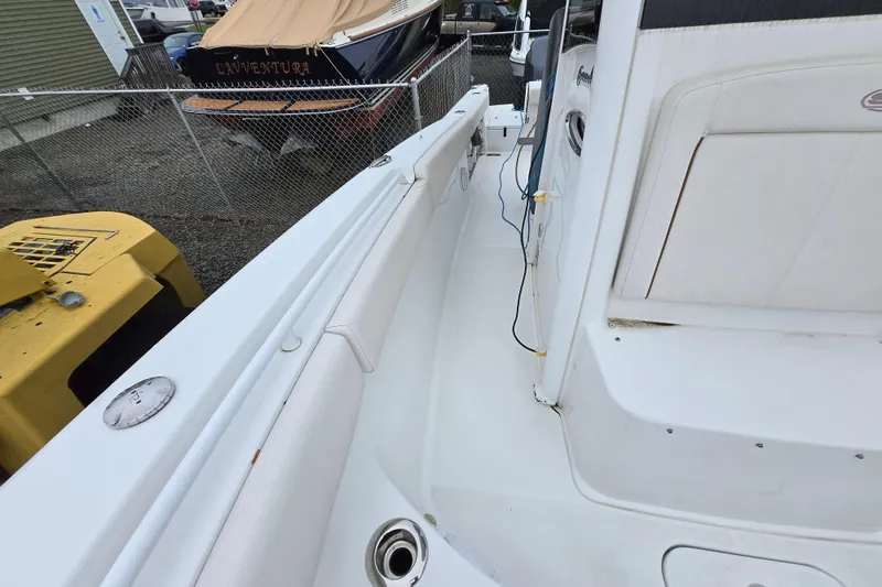 Slide: The Image of 2020 Sea Hunt Gamefish 25 boat interior, featuring white seating and deck details. - 10