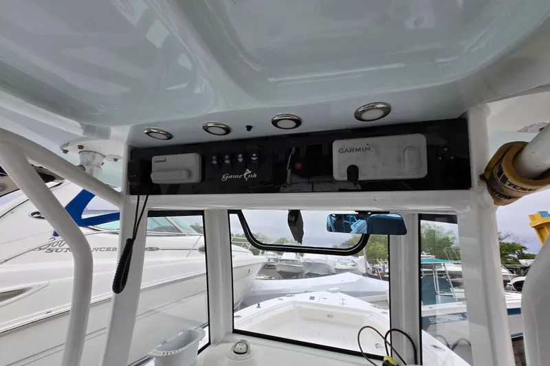Slide: The Image of 2020 Sea Hunt Gamefish 25 boat dashboard with Garmin electronics and overhead lighting. - 13