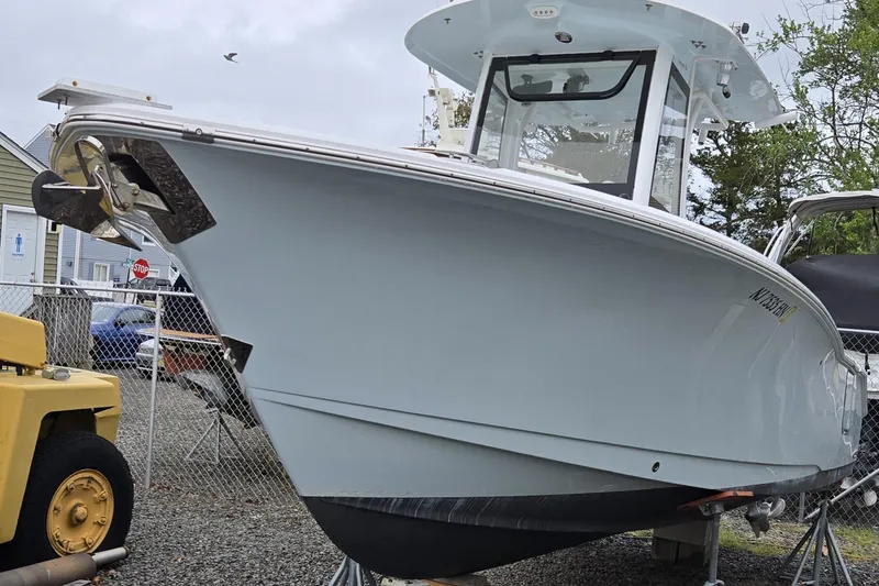 Slide: The Image of 2020 Sea Hunt Gamefish 25 boat on display in a yard setting. - 18