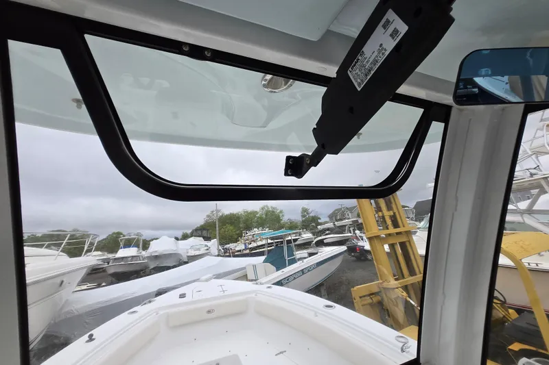 Slide: The Image of 2020 Sea Hunt Gamefish 25 boat interior view with docked boats in background. - 19