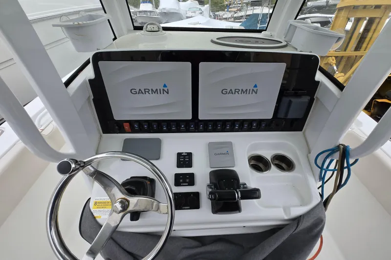 Slide: The Image of 2020 Sea Hunt Gamefish 25 helm with dual Garmin displays and steering wheel. - 2