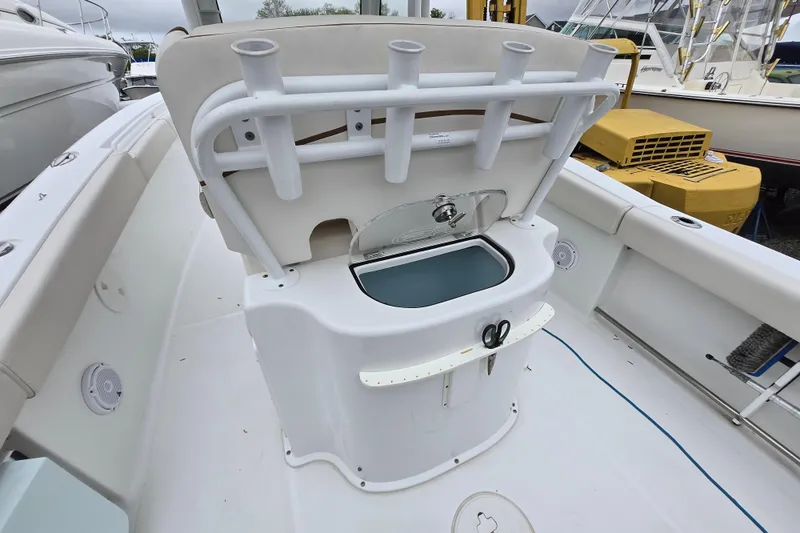 Slide: The Image of 2020 Sea Hunt Gamefish 25 boat interior with rod holders and storage compartment. - 20