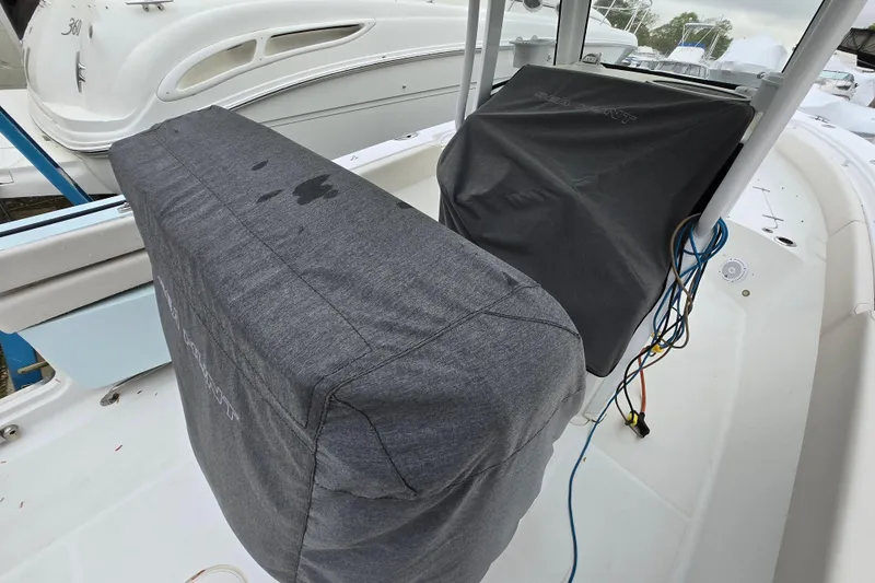 Slide: The Image of 2020 Sea Hunt Gamefish 25 boat interior with covered seats and visible wiring. - 25