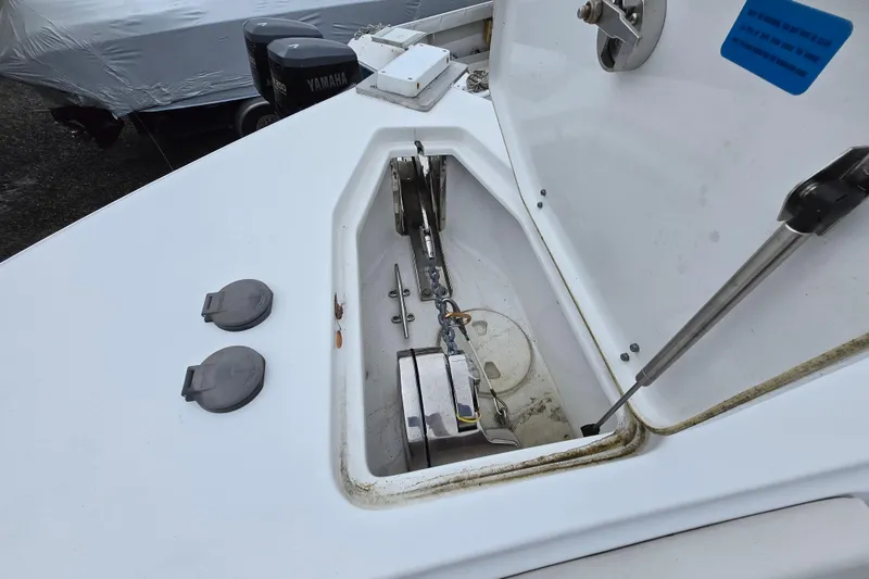Slide: The Image of 2020 Sea Hunt Gamefish 25 anchor compartment with Yamaha outboard motor in background. - 3