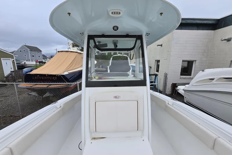 Slide: The Image of 2020 Sea Hunt Gamefish 25 boat, white interior, docked near other boats. - 8