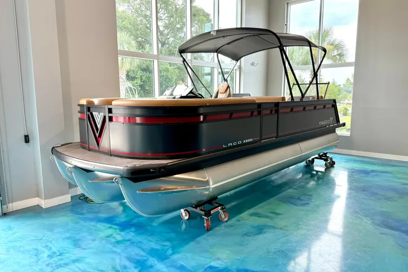 The Image of 2025 Viaggio Lago X-D pontoon boat in showroom, featuring sleek design and modern amenities. - 0