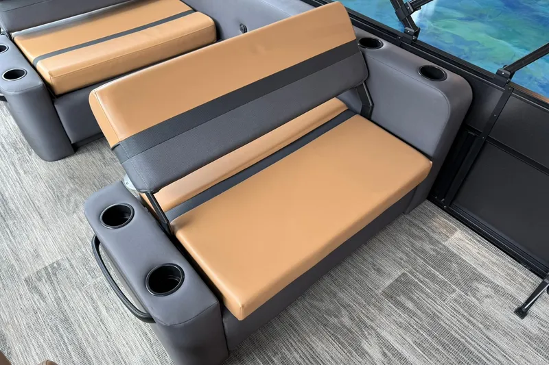 Slide: The Image of 2025 Viaggio Lago X-D boat interior with tan and gray seating, cup holders, and modern design. - 11