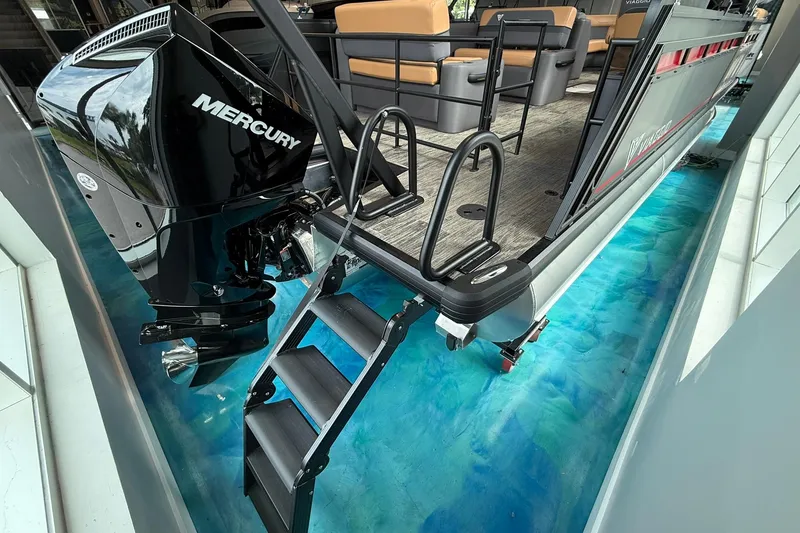 Slide: The Image of 2025 Viaggio Lago X-D boat with Mercury engine, docked on vibrant blue water. - 2