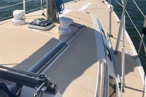 Slide: The Image of 1987 Catalina 30 MK II sailboat deck with rigging and winches, sailing on open water. - 12