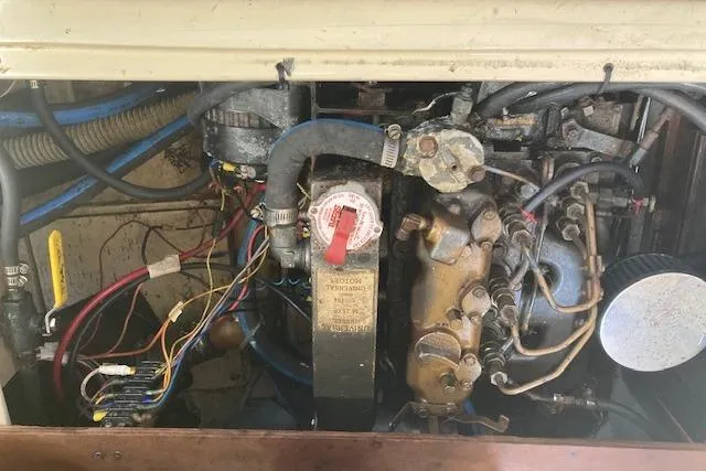 Slide: The Image of Engine compartment of a 1987 Catalina 30 MK II sailboat, showing wiring and mechanical components. - 18