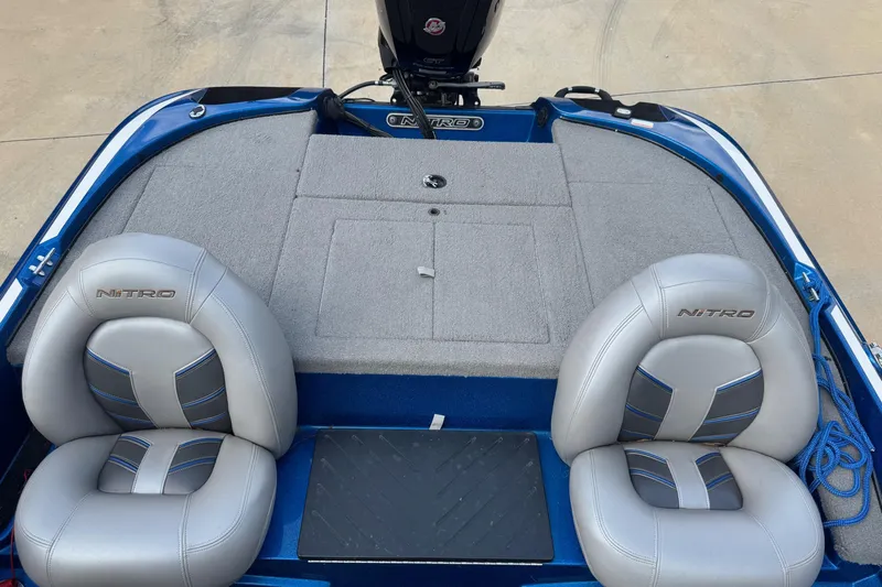 Slide: The Image of 2023 Nitro Z17 boat interior with gray seats and blue accents. - 4