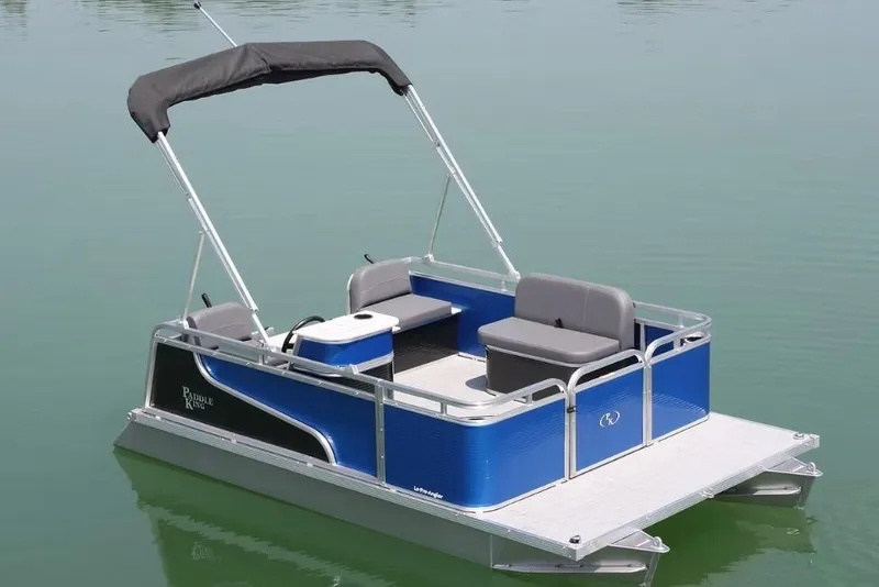 Slide: The Image of 2026 Paddle King Lo Pro Angler pontoon boat on calm water, featuring blue and silver design. - 4