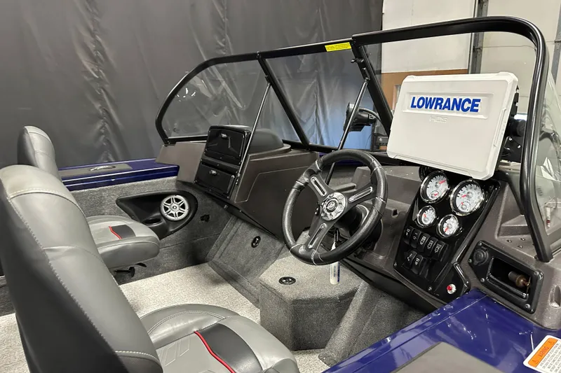 Slide: The Image of 2023 Tracker TARGA boat interior with steering wheel, gauges, and Lowrance display. - 13
