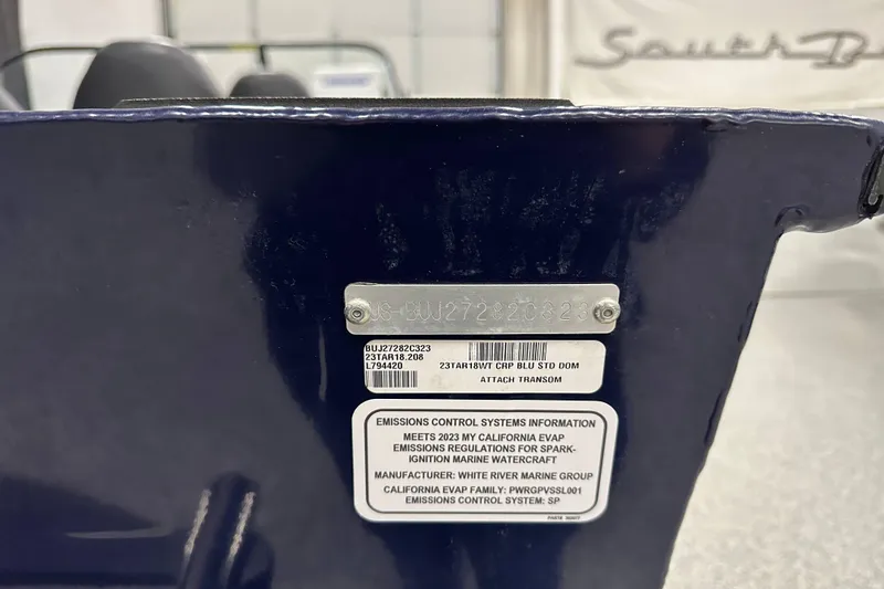 Slide: The Image of 2023 Tracker TARGA boat transom with emissions control information and serial number plate. - 15