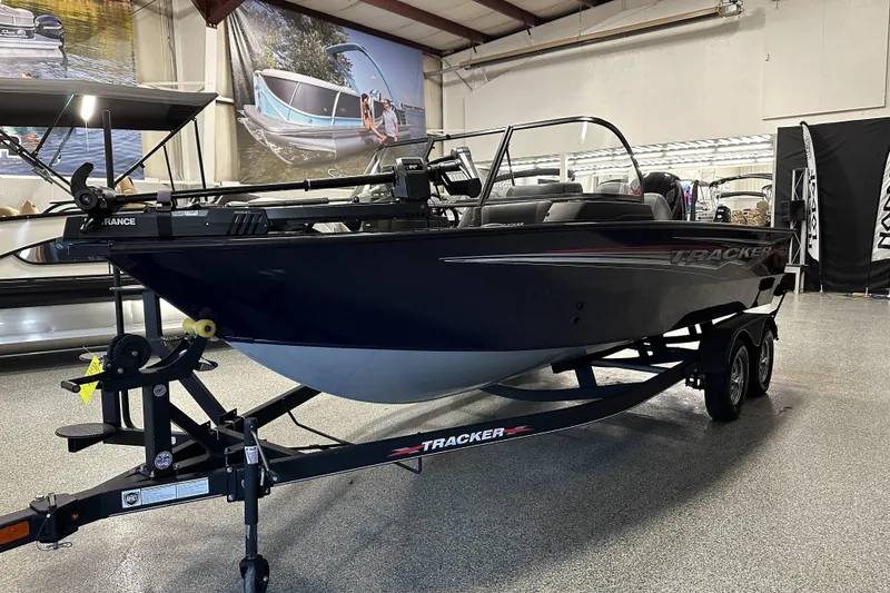 Slide: The Image of 2023 Tracker TARGA boat on trailer in showroom, featuring sleek design and modern equipment. - 5