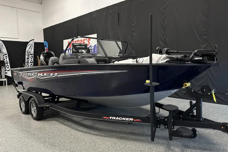 Slide: The Image of 2023 Tracker TARGA boat on trailer in showroom, featuring sleek design and modern equipment. - 6