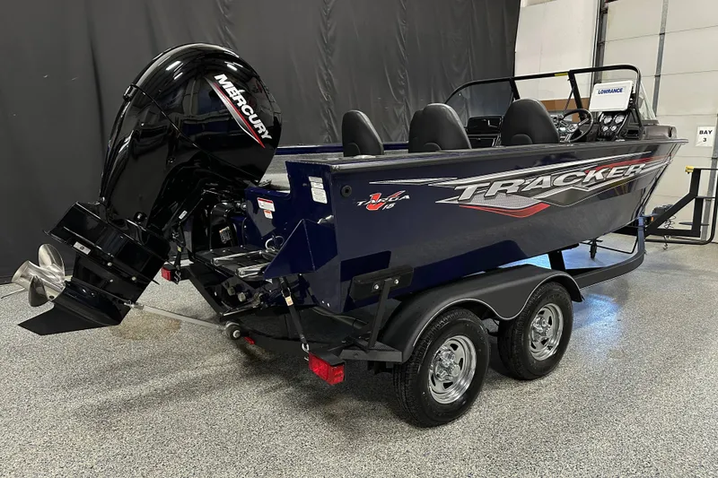 Slide: The Image of 2023 Tracker TARGA boat with Mercury engine on a trailer in a showroom. - 7