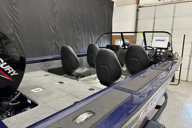 Slide: The Image of 2023 Tracker TARGA boat interior with seating and Mercury engine, featuring Lowrance electronics. - 8