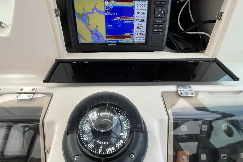 Slide: The Image of Grady-White Gulfstream 232 boat dashboard with Garmin GPS and compass, 2004 model. - 11
