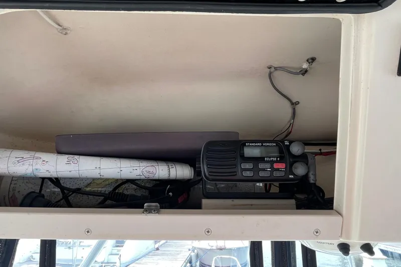 Slide: The Image of 2004 Grady-White Gulfstream 232 boat interior with radio and navigation charts. - 13