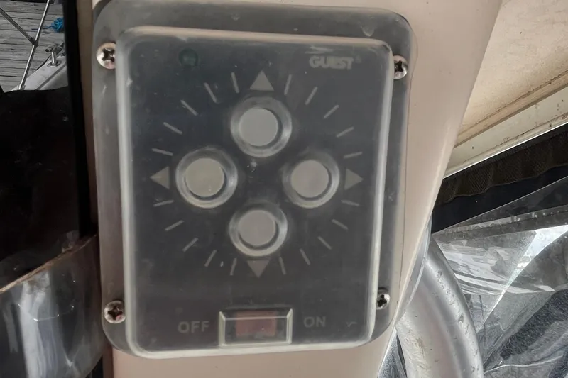 Slide: The Image of Control panel on a 2004 Grady-White Gulfstream 232 boat, featuring directional buttons. - 14