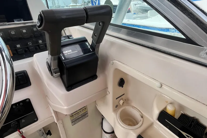 Slide: The Image of 2004 Grady-White Gulfstream 232 boat cockpit with Yamaha throttle control. - 16