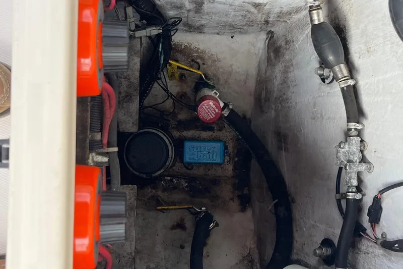 Slide: The Image of 2004 Grady-White Gulfstream 232 boat engine compartment with wiring and hoses. - 20